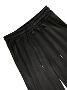Black jersey joggers with elastic waistband and drawstring, close-up flat view | Chaps London