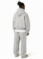 Man wearing gray oversized hoodie and matching straight-leg jogger sweatpants outdoors | Chaps London