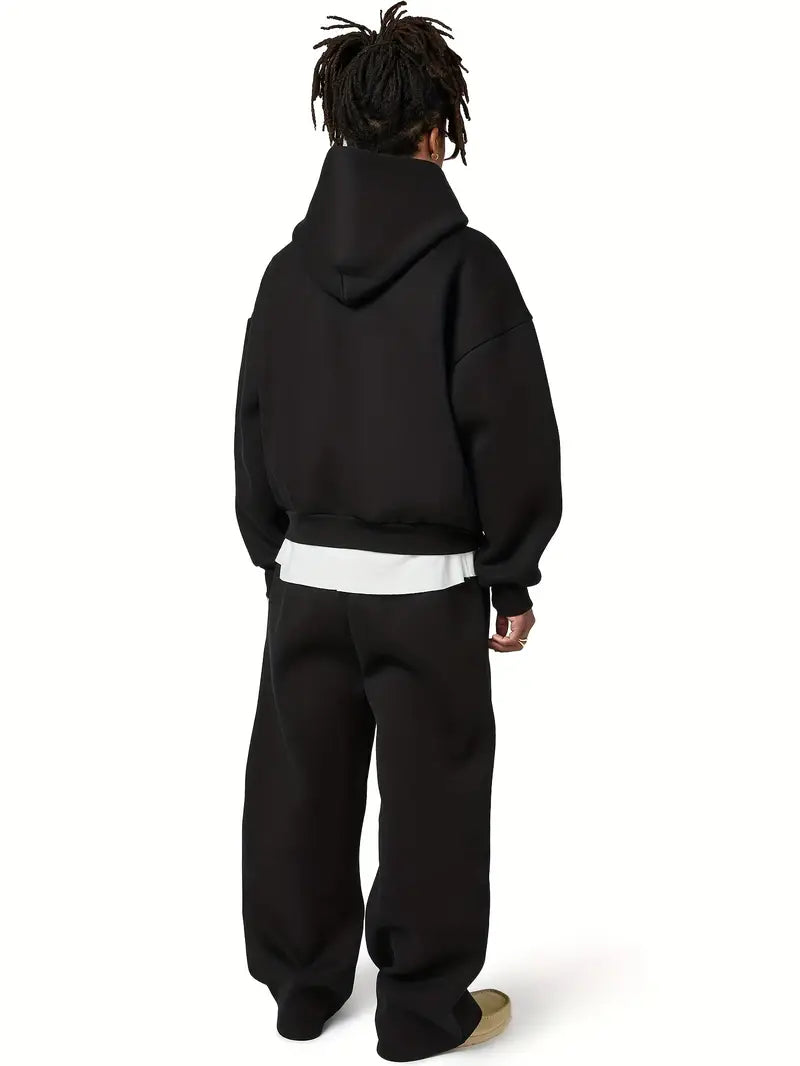 Man wearing black oversized hoodie and matching joggers, rear view | Chaps London