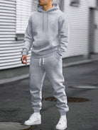 Man in a grey hoodie and matching joggers tracksuit set, standing on a street | Chaps London