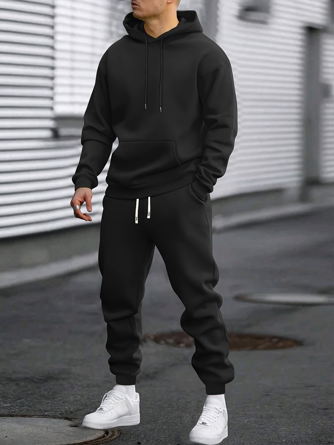 Man in a black hoodie and joggers tracksuit set | Chaps London