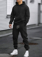 Man in a black hoodie and joggers tracksuit set | Chaps London