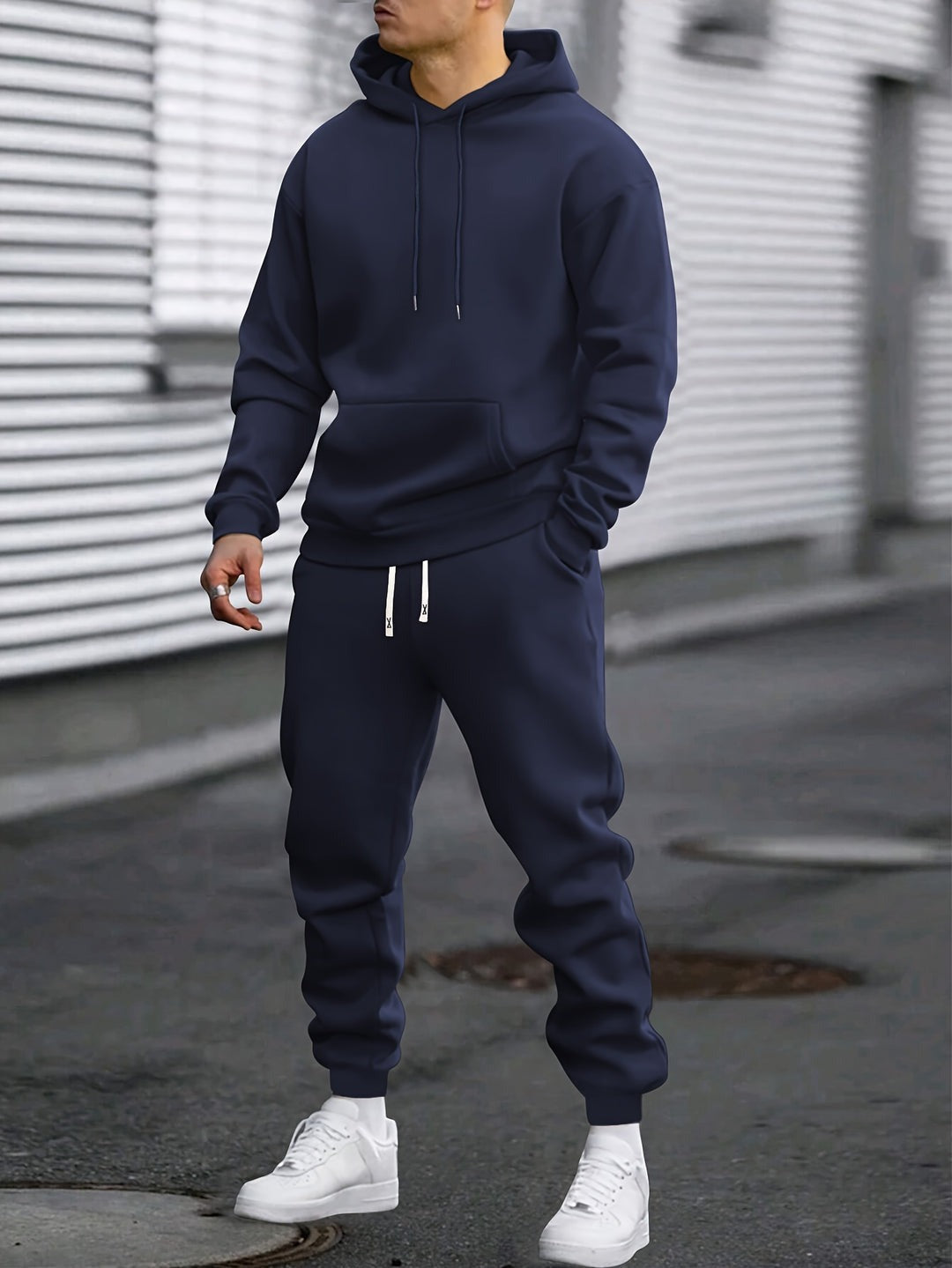 Man in a navy hoodie and joggers tracksuit set | Chaps London