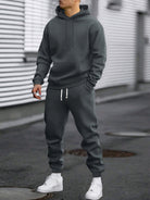 Man in a dark grey hoodie and joggers tracksuit set | Chaps London