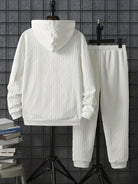 White textured hoodie and joggers set on hangers, back view | Chaps London