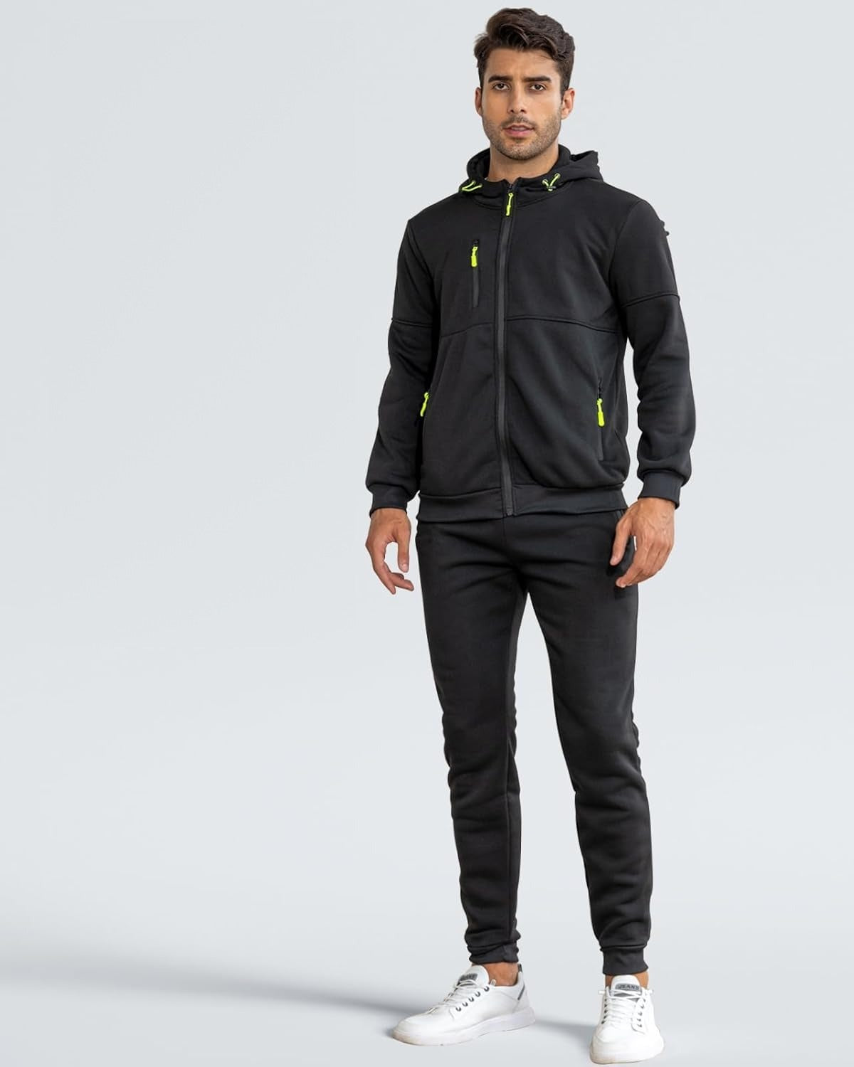Man in a black zip hoodie and joggers tracksuit with neon green zip pulls, front view | Chaps London