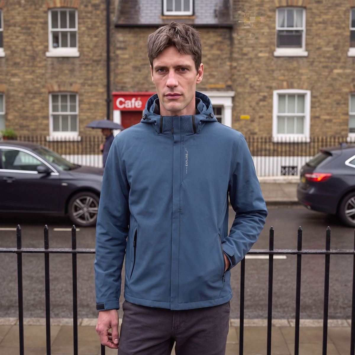 Model wearing the men's blue waterproof hardshell jacket