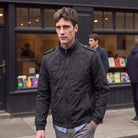Man wearing the black windbreaker with stand collar