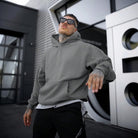 Man wearing oversized grey plain hoodie with kangaroo pocket, outdoor setting | Chaps London