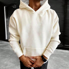 Cream plain hoodie with kangaroo pocket worn by man, hood up | Chaps London