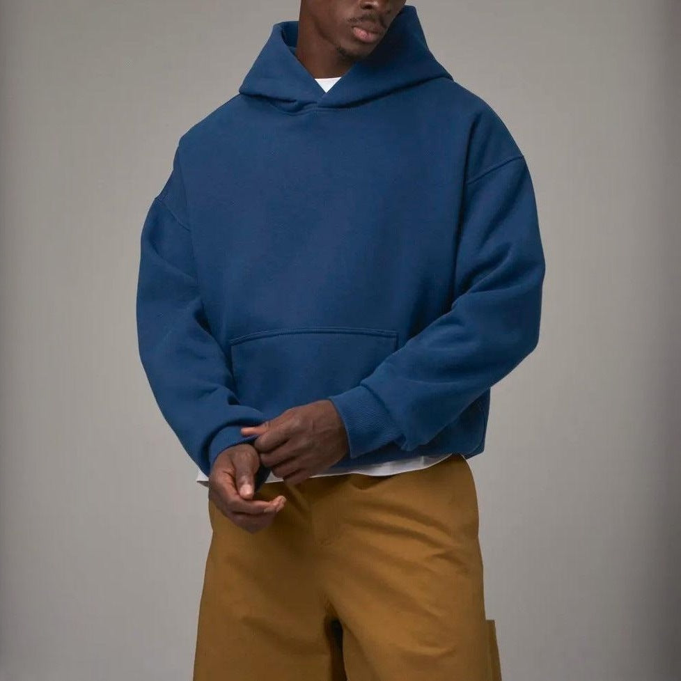 Man wearing oversized blue hoodie with mustard trousers, front view | Chaps London