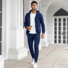 Man wearing navy zip hoodie and matching joggers, walking outdoors | Chaps London