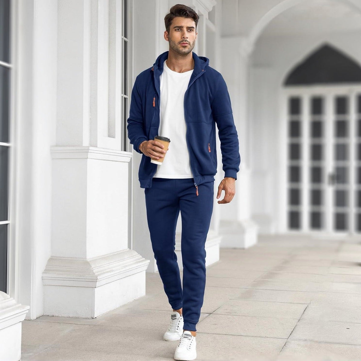Man wearing navy zip hoodie and matching joggers, walking outdoors | Chaps London