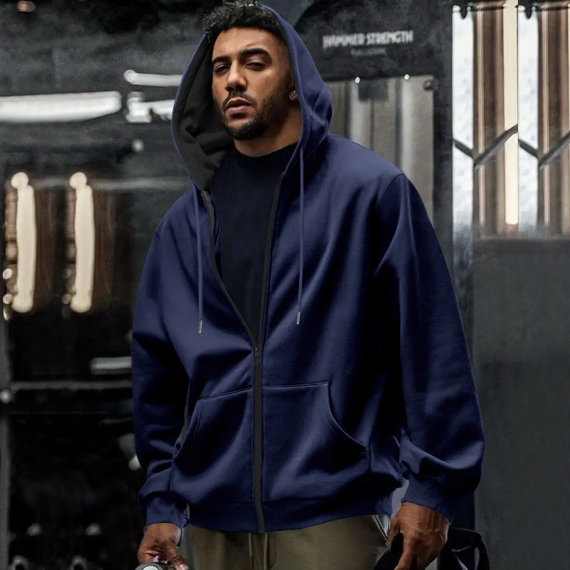 Men's oversized zip-up hoodie in navy, worn, front view