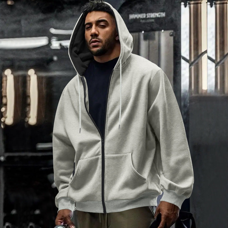 Men's oversized zip-up hoodie in light grey, worn, front view
