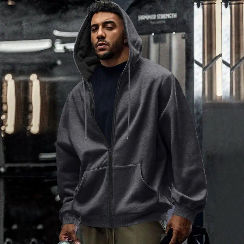 Men's oversized zip-up hoodie in dark grey, worn, front view