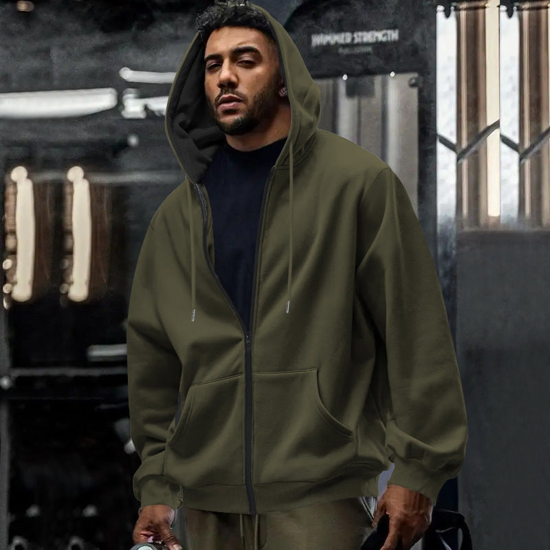 Men's oversized zip-up hoodie in olive green, worn, front view