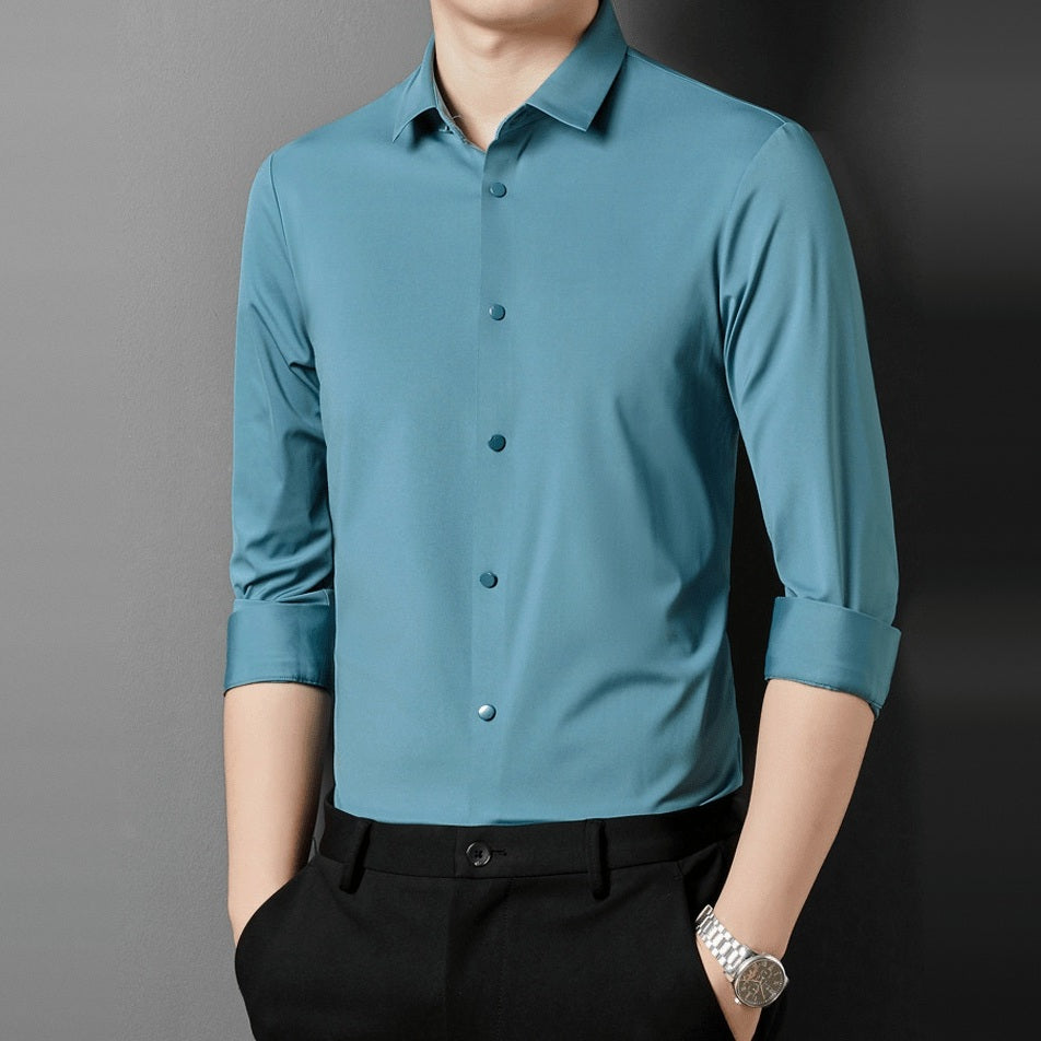 Man wearing teal point collar shirt with rolled sleeves and black pants | Chaps London