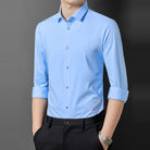 Man wearing light blue point collar long sleeve shirt with black pants | Chaps London