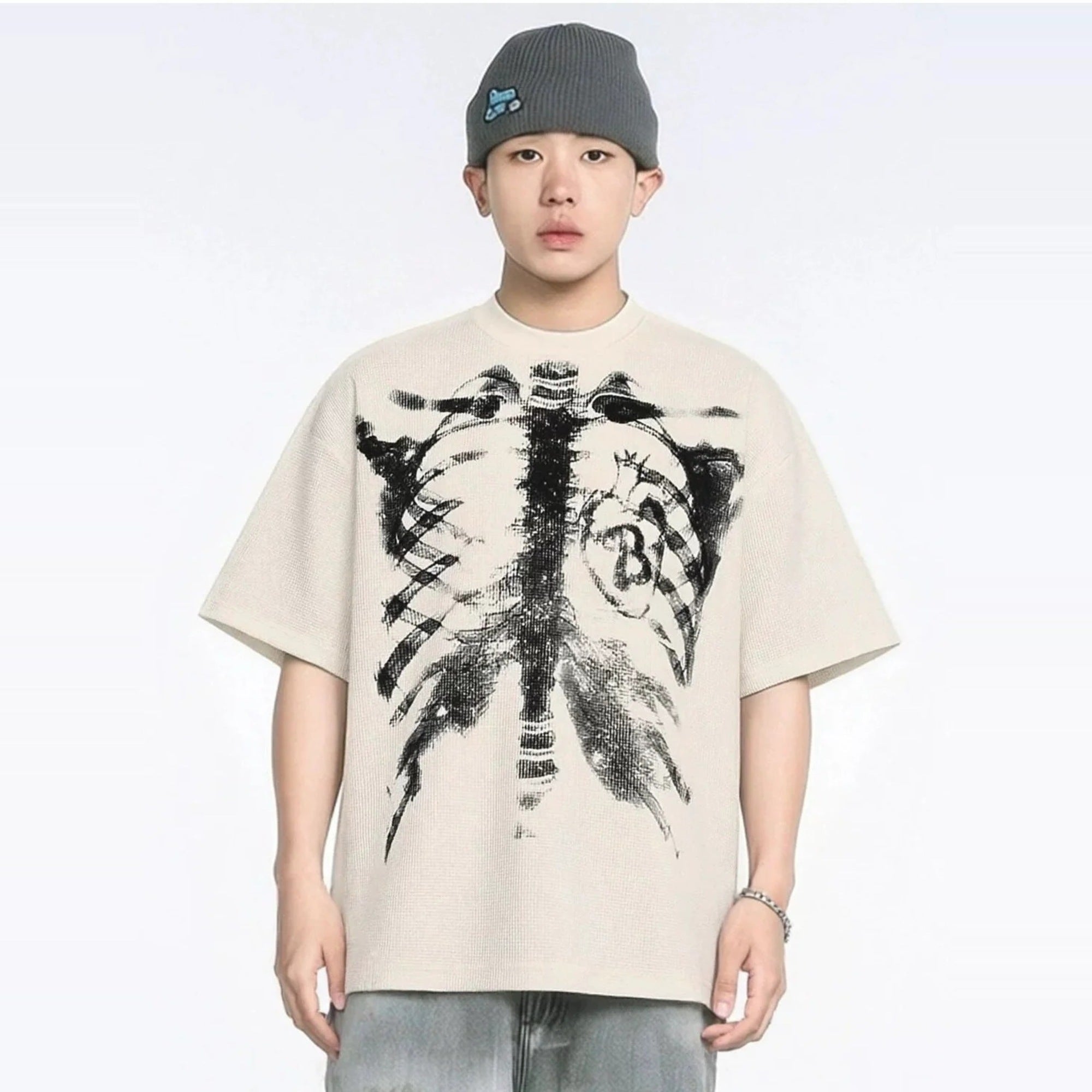 Beige oversized T-shirt with skeleton rib cage print, worn by young man | Chaps London