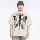 Beige oversized T-shirt with skeleton rib cage print, worn by young man | Chaps London