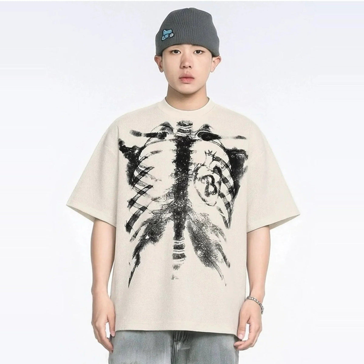Beige oversized T-shirt with skeleton rib cage print, worn by young man | Chaps London