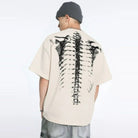 Beige oversized t-shirt with spine skeleton print, worn by man from behind | Chaps London