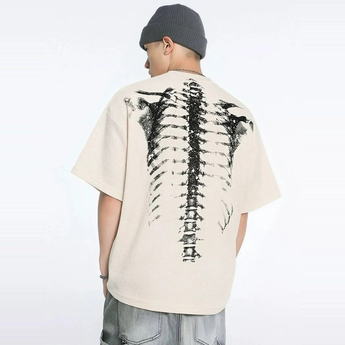 Beige oversized t-shirt with spine skeleton print, worn by man from behind | Chaps London
