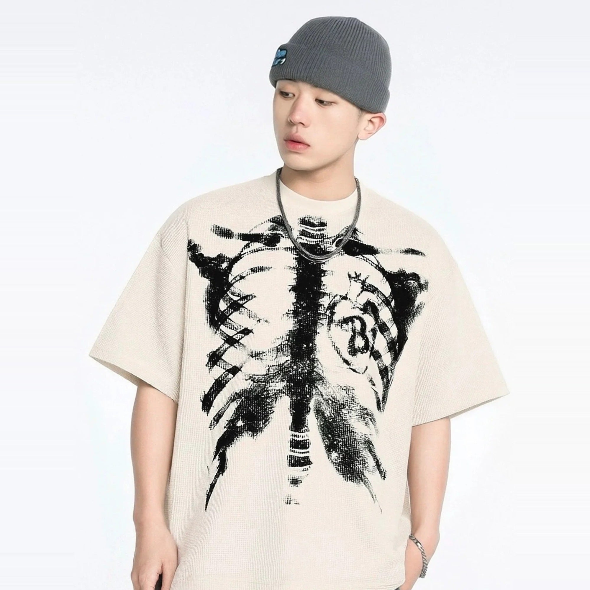 Beige oversized T-shirt with skeletal rib cage print, worn by young man | Chaps London