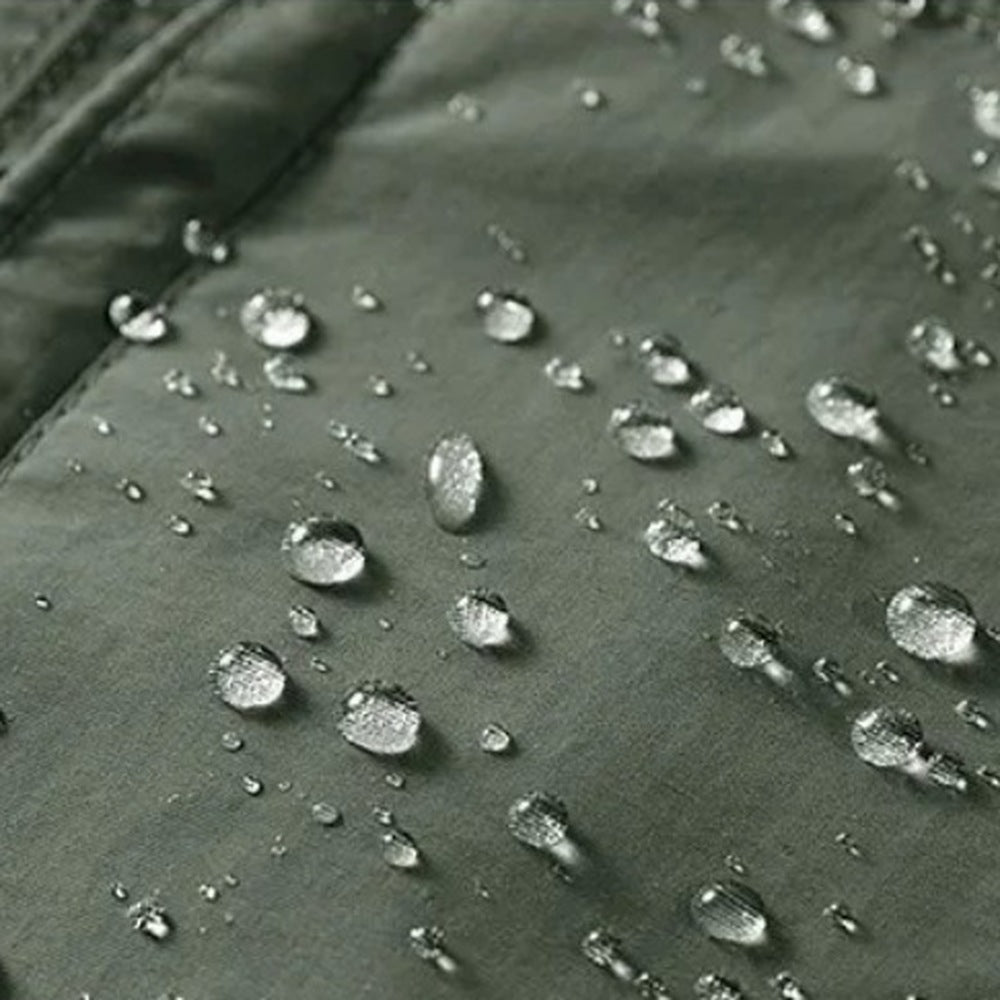 Close-up of olive green waterproof fabric with beaded water droplets | Chaps London