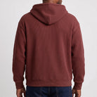 Man wearing maroon ribbed hoodie, rear view, paired with blue jeans | Chaps London