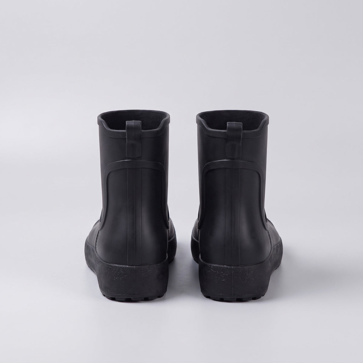 Black ankle wellies, rear view, flat lay on gray background | Chaps London