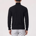 Man wearing black fine knit turtleneck jumper, back view, gray trousers | Chaps London