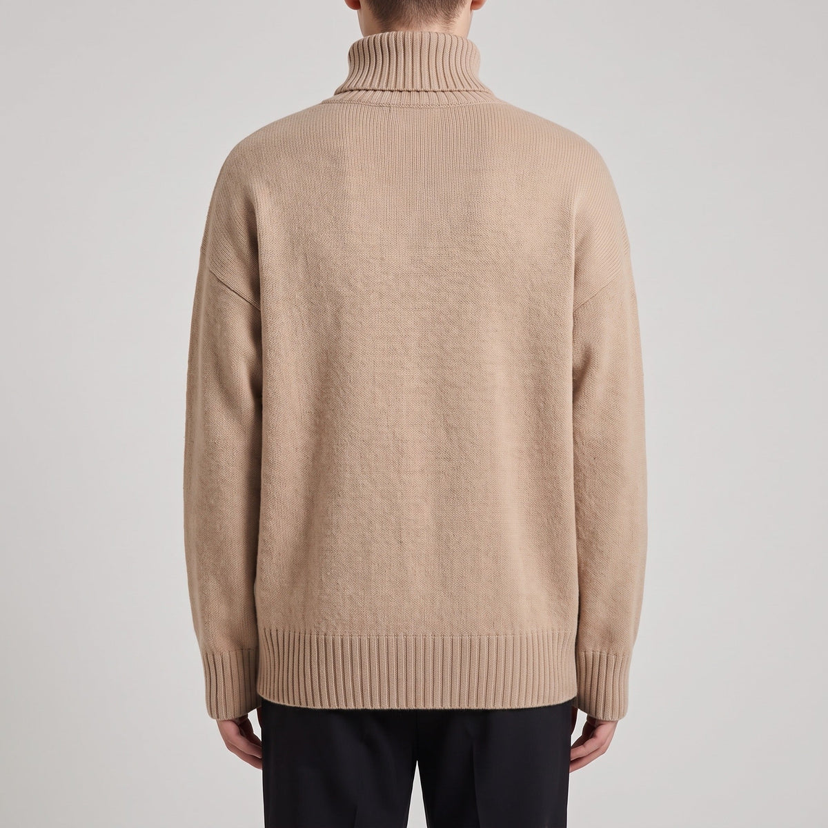 Beige oversized roll neck jumper worn by man, ribbed knit texture, back view | Chaps London