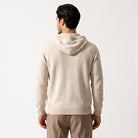 Man wearing beige knit hooded sweater, back view, with brown trousers | Chaps London