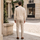 Man wearing beige ribbed zip cardigan with trousers, standing outdoors on street | Chaps London