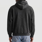 Man wearing dark grey washed hoodie, back view, worn with jeans | Chaps London