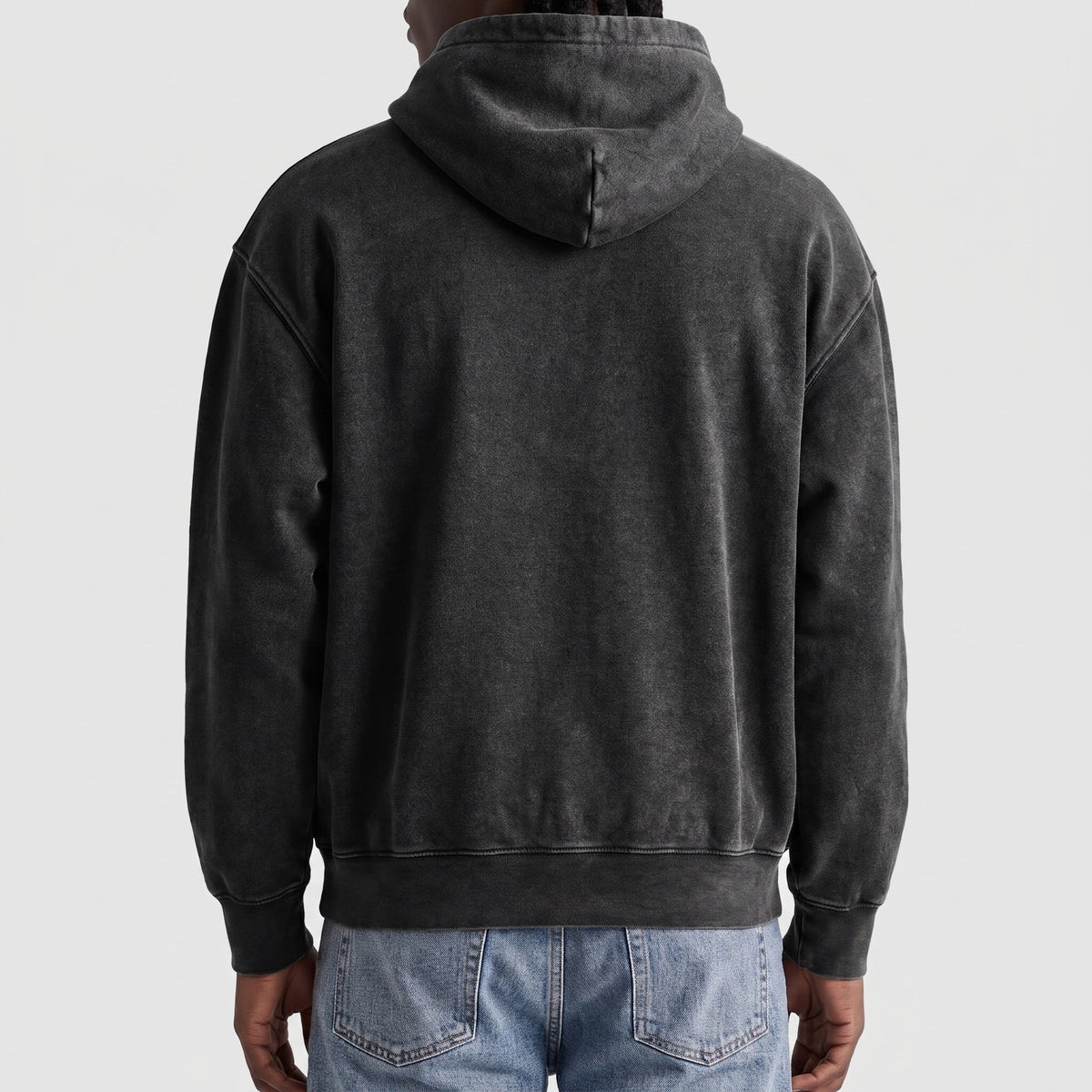 Man wearing dark grey washed hoodie, back view, worn with jeans | Chaps London