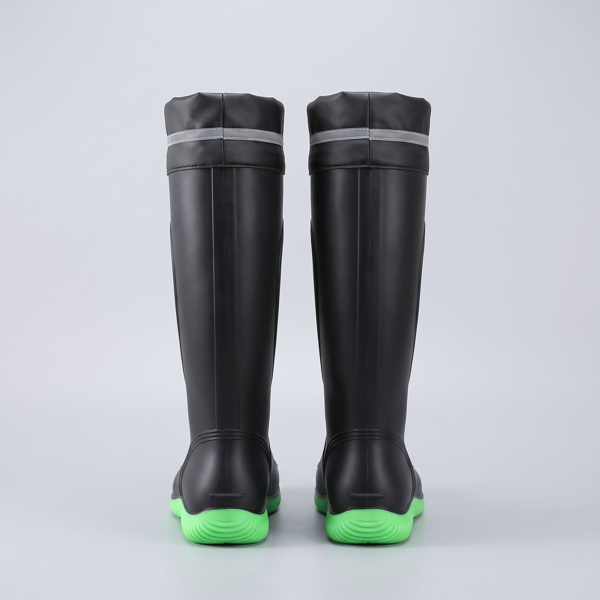 Black knee-high wellies with green soles, rear view, flat lay | Chaps London
