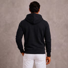 Man wearing black full-zip hoodie with hood, viewed from behind | Chaps London
