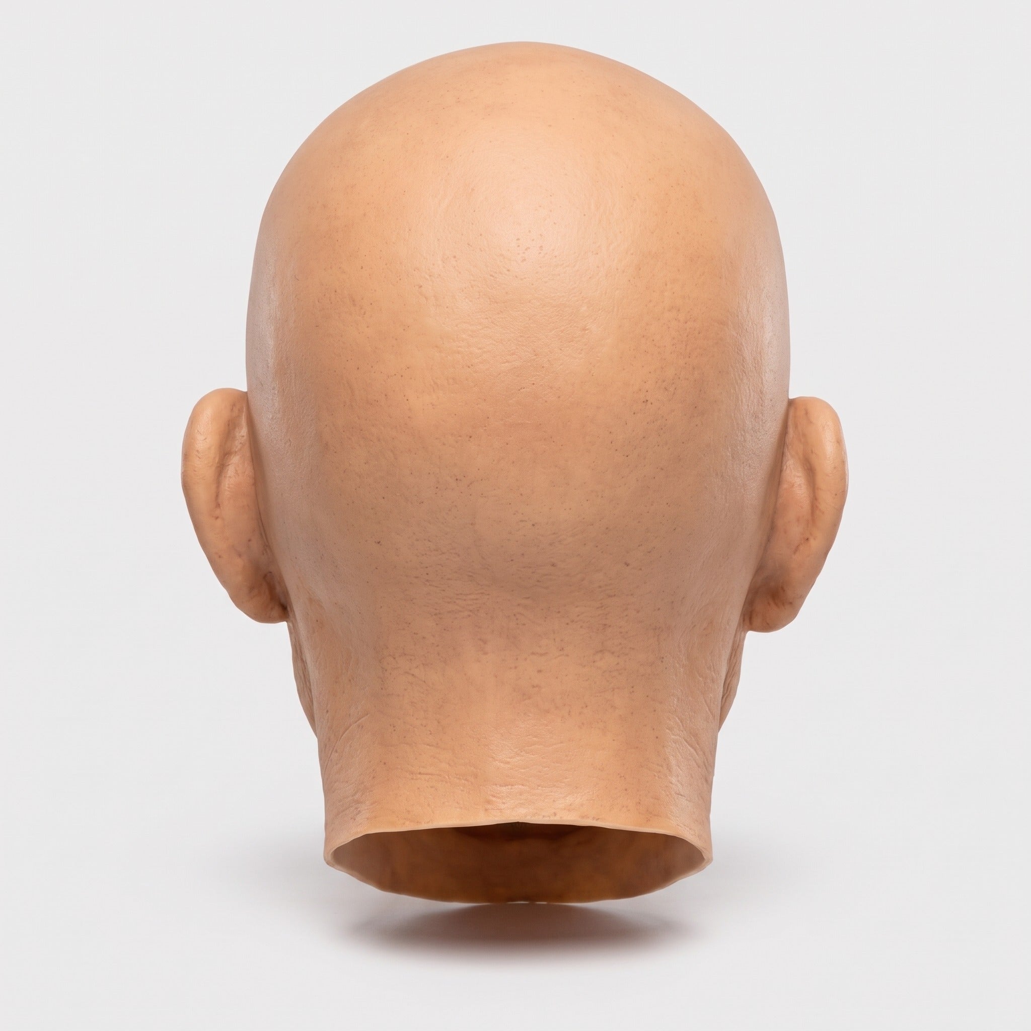 Rear view of bald latex mask head, skin-tone color, no hair visible | Chaps London