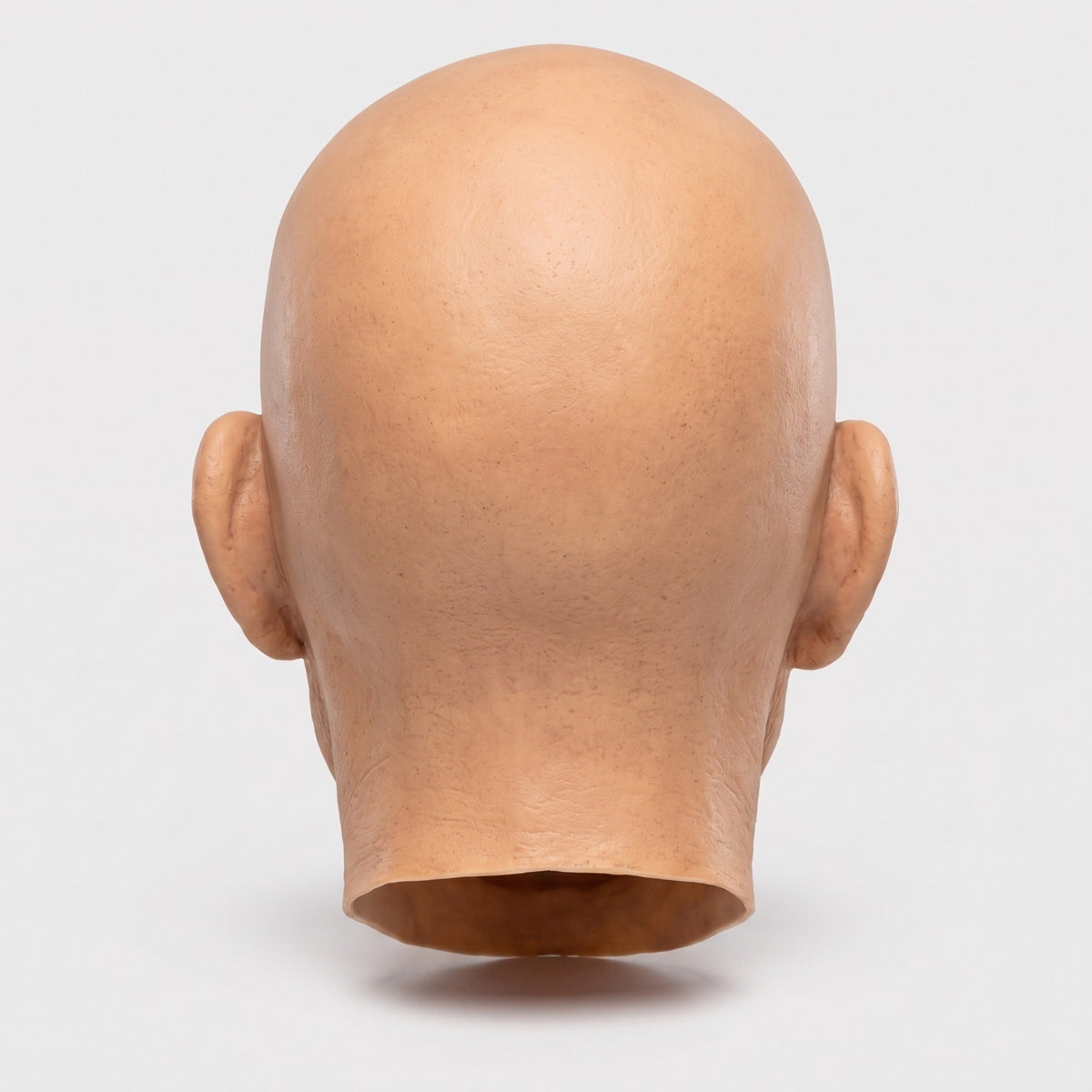 Rear view of bald latex mask head, skin-tone color, no hair visible | Chaps London