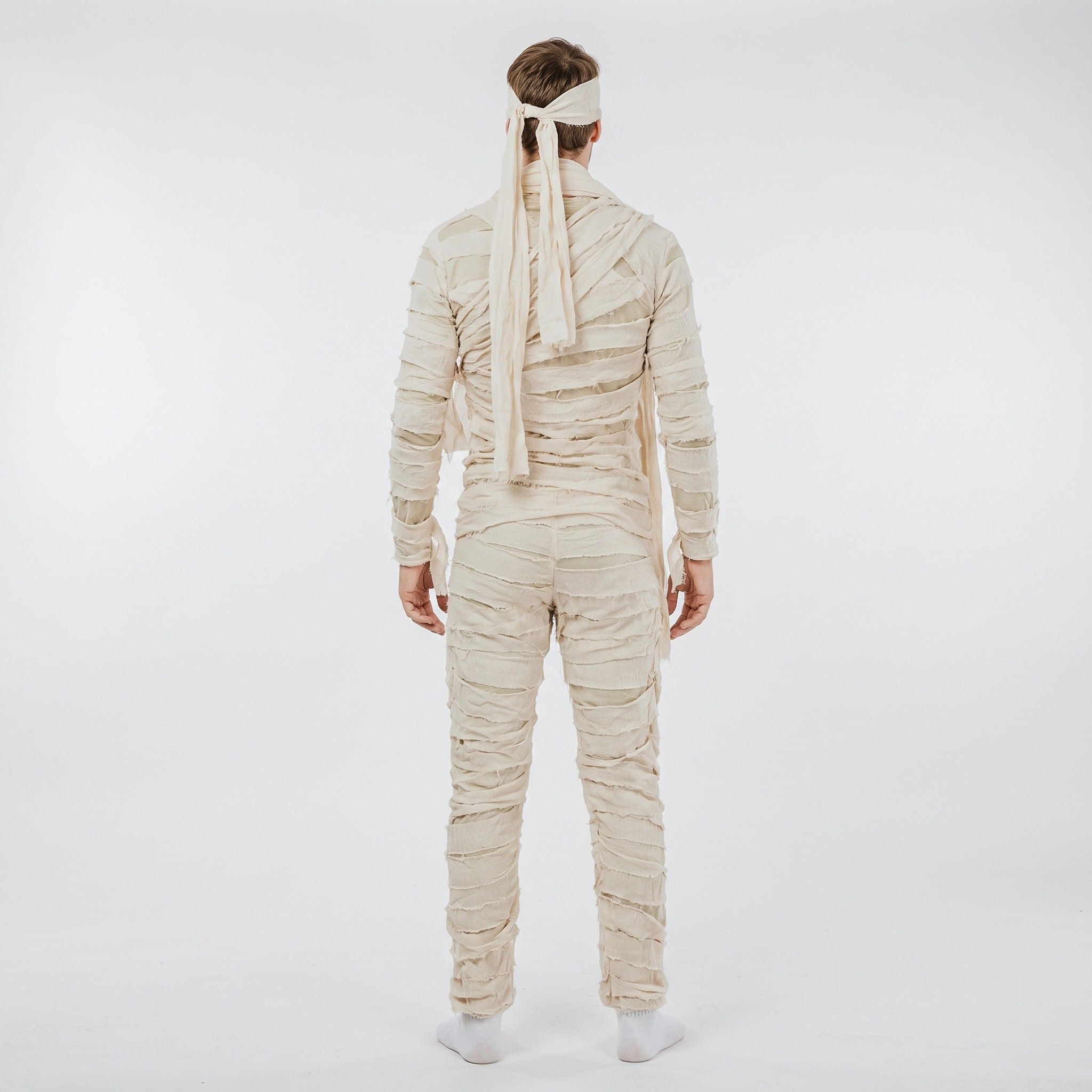 Man wearing beige mummy costume jumpsuit with headband, rear view | Chaps London