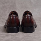 Burgundy oxford dress shoes rear view, flat lay on gray surface | Chaps London