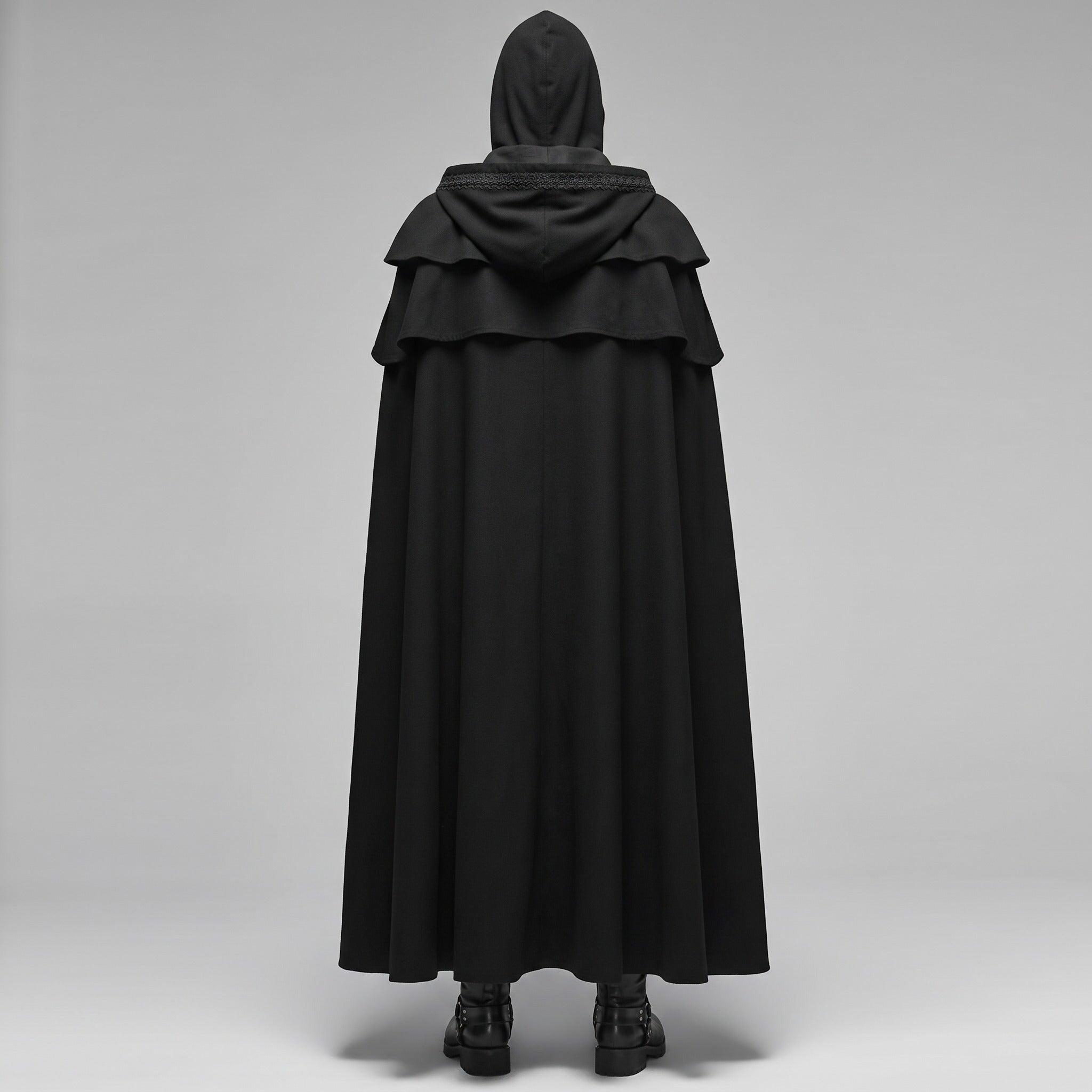 Black hooded cape with layered shoulder cowl, worn by person, back view | Chaps London
