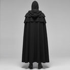 Black hooded cape with layered shoulder cowl, worn by person, back view | Chaps London
