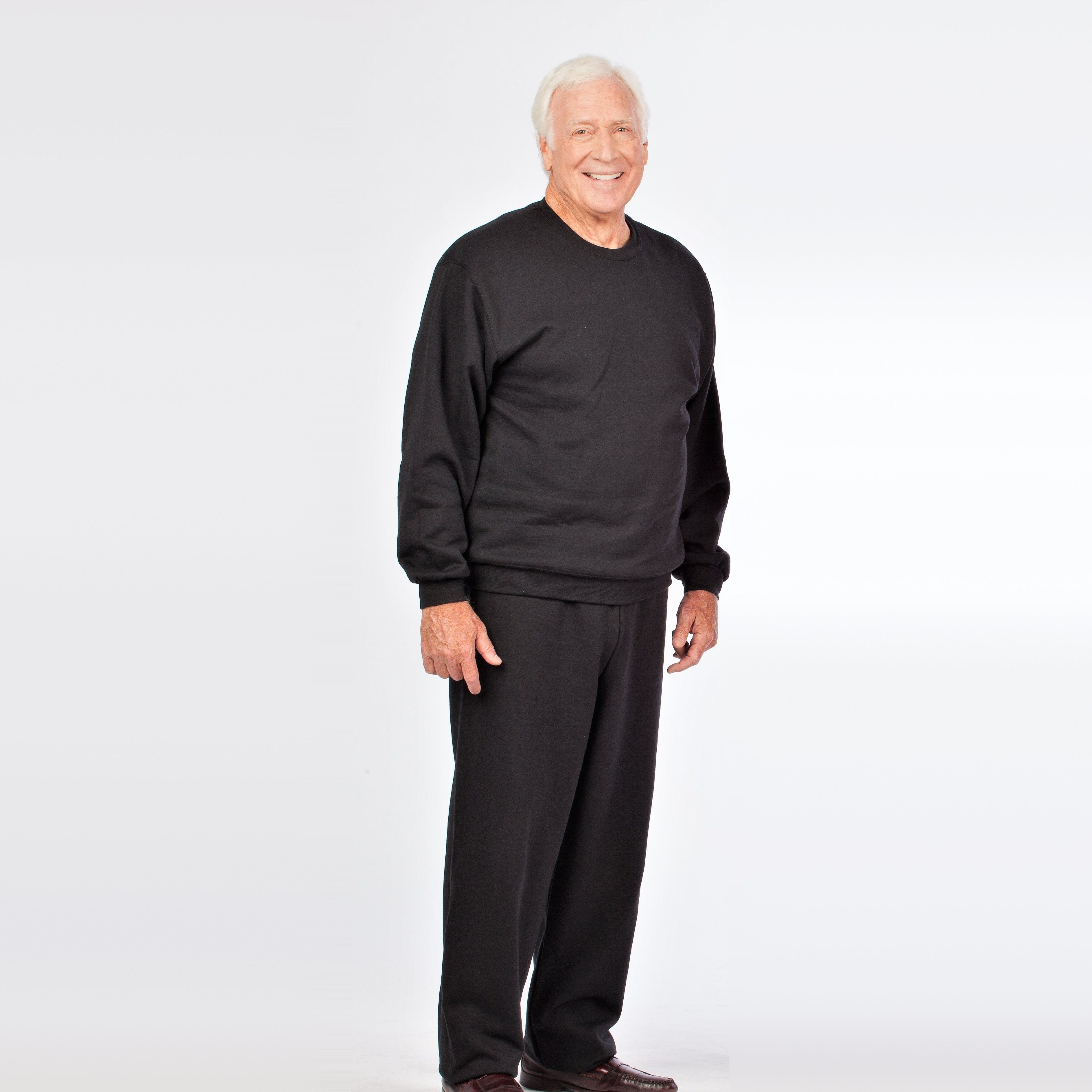 Older man wearing black fleece tracksuit, crew neck sweatshirt and joggers, worn | Chaps London
