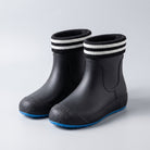 Black ankle wellies with striped cuffs and blue soles, shown flat | Chaps London