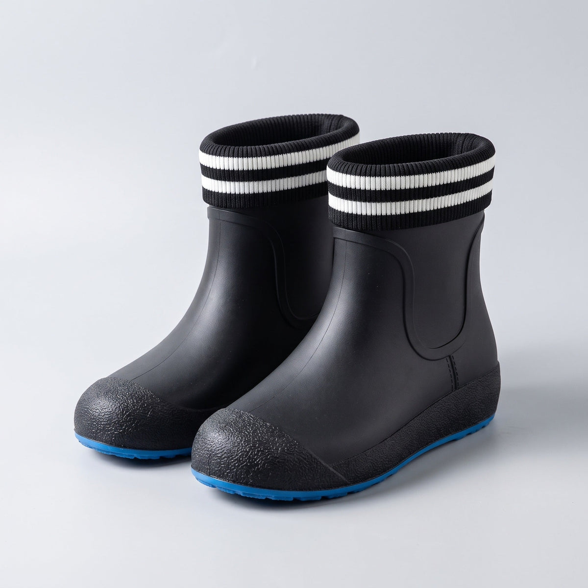 Black ankle wellies with striped cuffs and blue soles, shown flat | Chaps London