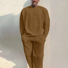 Man wearing textured brown knit sweater and matching trousers outdoors | Chaps London